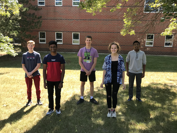 Five Bartlett High School students stand outside the school 
